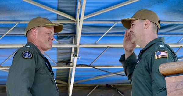 Capt. Shawn O'Connor, right, salutes Capt. Douglas Peterson as he takes command of NAS Lemoore Friday afternoon.